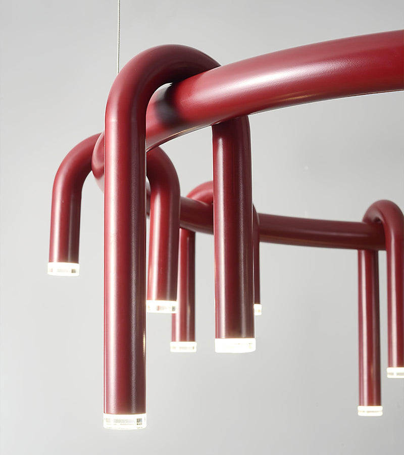 Close-up of wine-red curved metal arms and illuminated LED tips