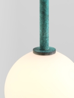 Detail of the green lamp stem and collar above the illuminated globe.