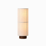 Sora Lighting Collection lamp with a cylindrical fabric shade and dark base