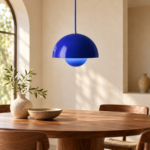 Pavo Double-Dome Pendant Lamp in blue above a walnut dining table, AI design visualization