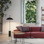 Black Doma floor lamp beside a sofa and large window