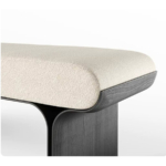 Close-up reference of cream textured upholstery and dark charcoal wood grain on the Sylva bench base