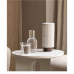 Sora table lamp on a side table in a square lifestyle image