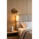 Veyra Cloud Stone Light wall lamp beside a bed