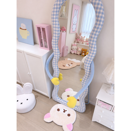 Angled view of the Hug Blue Gingham Floor Mirror with pale-blue padded arms