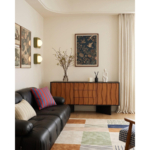 Wave-front wooden sideboard with a black frame beside a sofa.