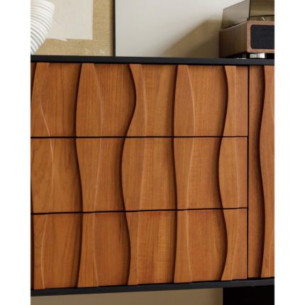 Close view of the carved wave-like front and central drawer fronts.