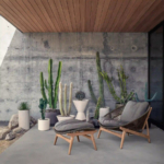 Woven lounge chair and footrest in a courtyard with cacti