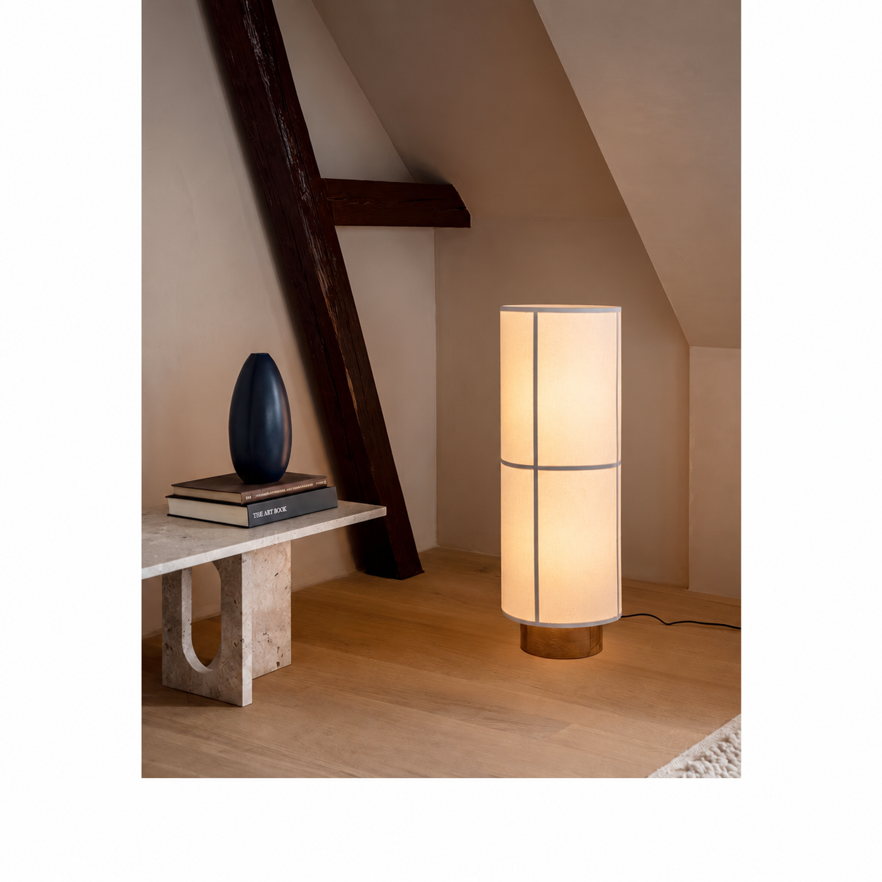 Plug-in floor lamp with a cylindrical fabric shade in an interior