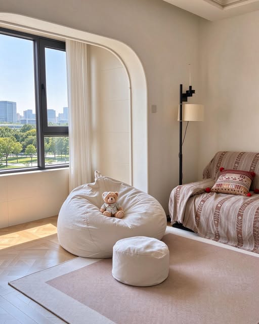 Light-coloured rounded lounge seat and small footstool in a BUNISE Instagram room photograph