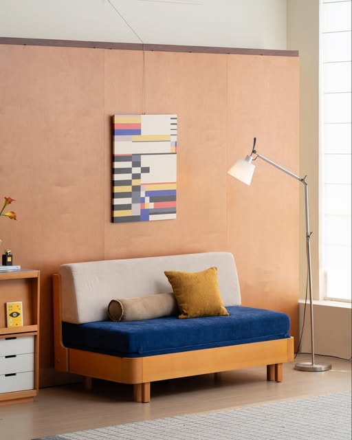Blue-seat sofa with a pale backrest and wood-tone frame in a BUNISE Instagram photograph
