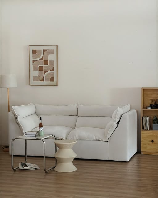 Pale straight sofa with loose cushions in a BUNISE Instagram living room photograph