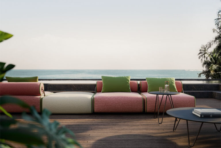 Design reference: Front view of pink and cream seating modules with green accent cushions and cylindrical backrests.