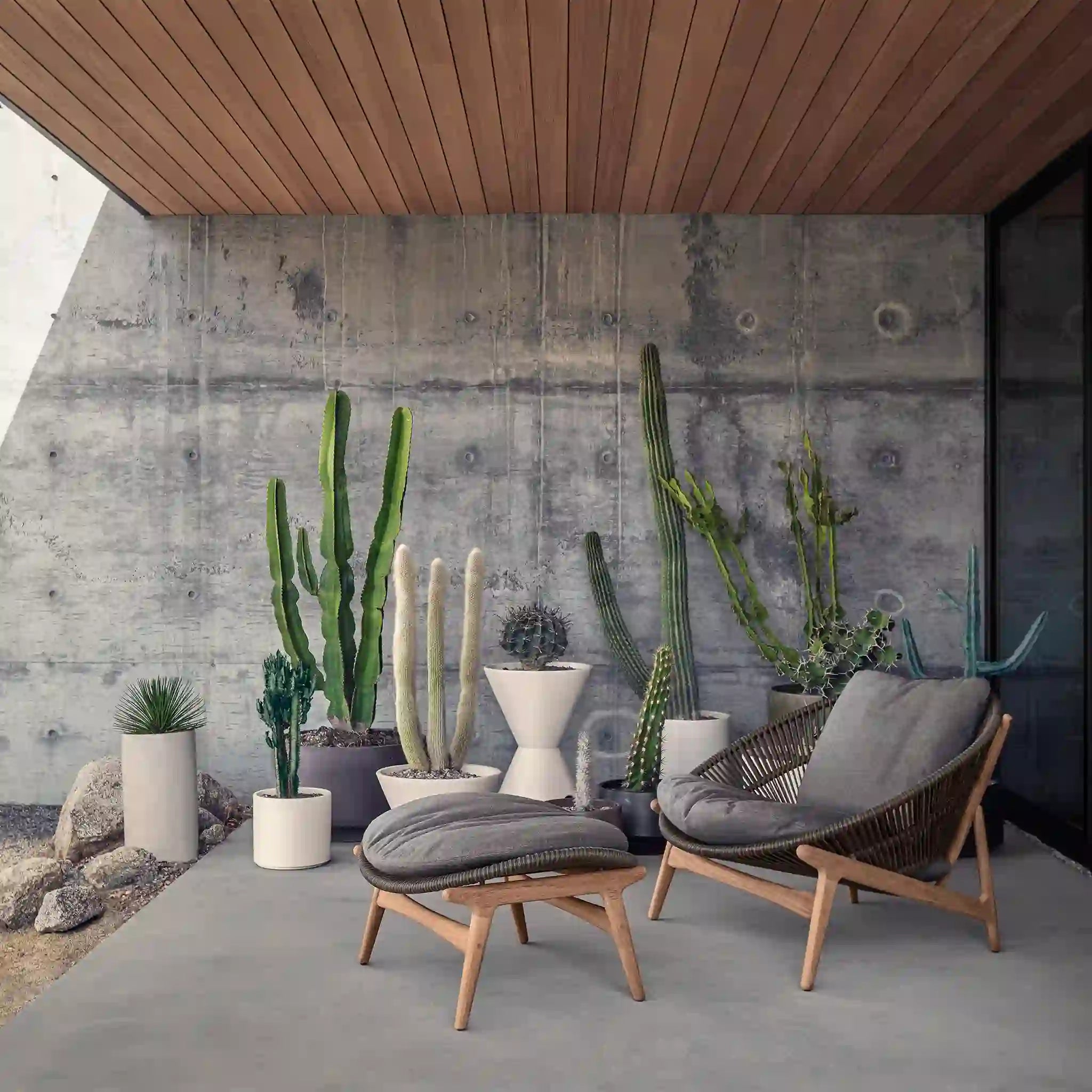Woven lounge chair and footrest with grey cushions in a courtyard
