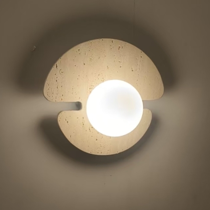Showroom photograph of a notched yellow travertine wall light with a white glass globe